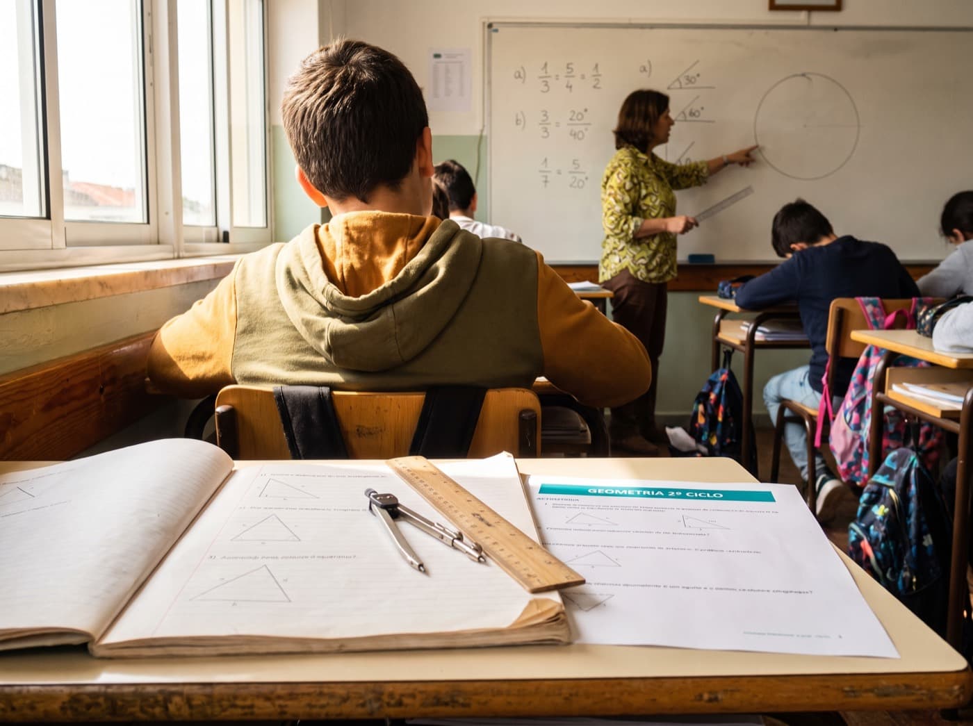 Middle-school room · geometry in the notebook